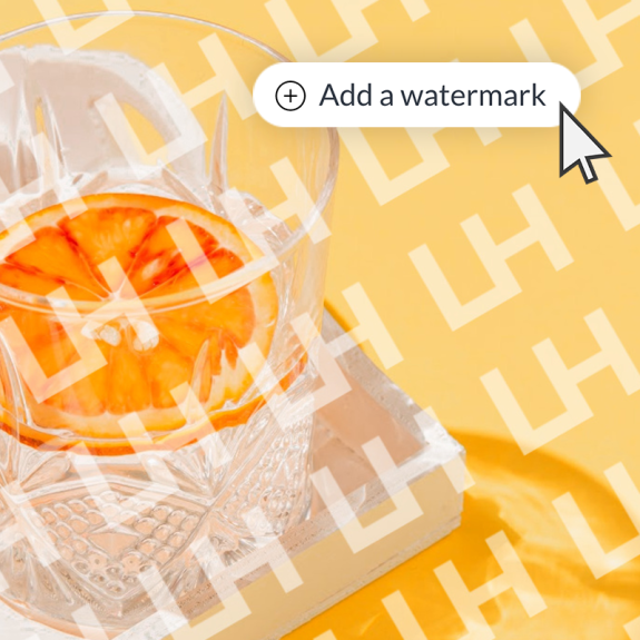 Cocktail glass with orange in it. Watermark pattern across image, highlighting PicMonkey's "Add a watermark" feature. 
